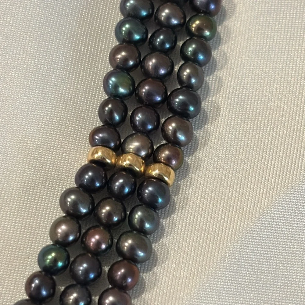 Tahitian black pearl bracelet with 14k gold filigree clasp.